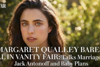 Margaret Qualley posing for Vanity Fair in a white towel with the I Love New York logo.