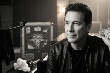 Tommy DeCarlo performing live on stage with the rock band Boston.