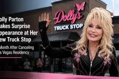 Dolly Parton smiling while cutting a ribbon with large bedazzled pink scissors in front of her new Tennesseean travel stop.